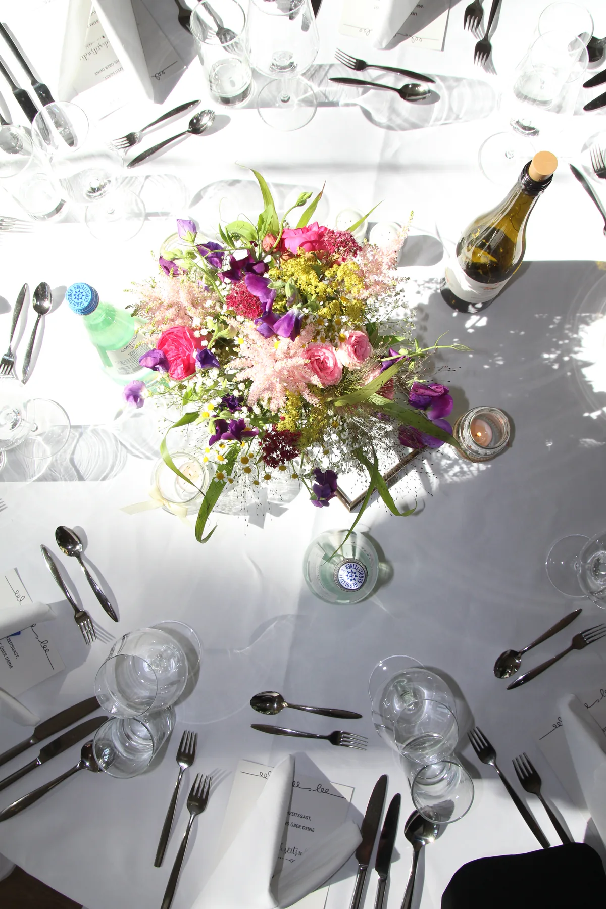 Elegant event table detail with florals and place settings
