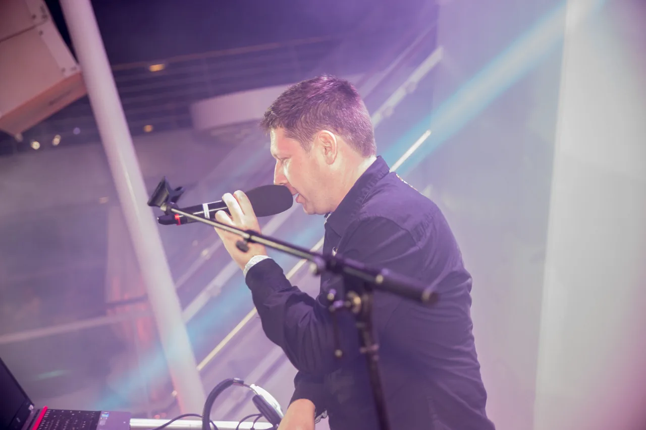 Sven speaking on the microphone during an event