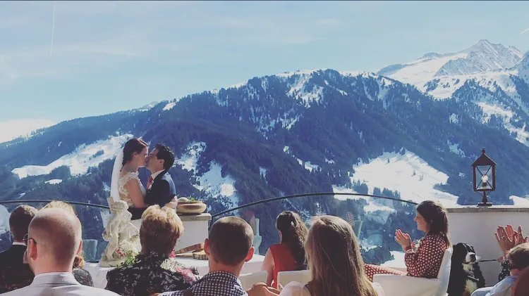 Outdoor mountain wedding ceremony with guests seated for the service